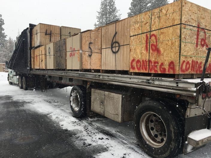 A flatbed truck loaded with crates of donated equipment marked for Condega